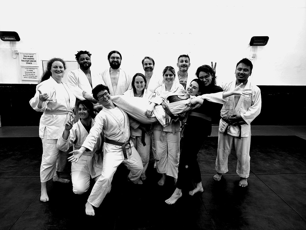 Club members striking poses on the mat after training