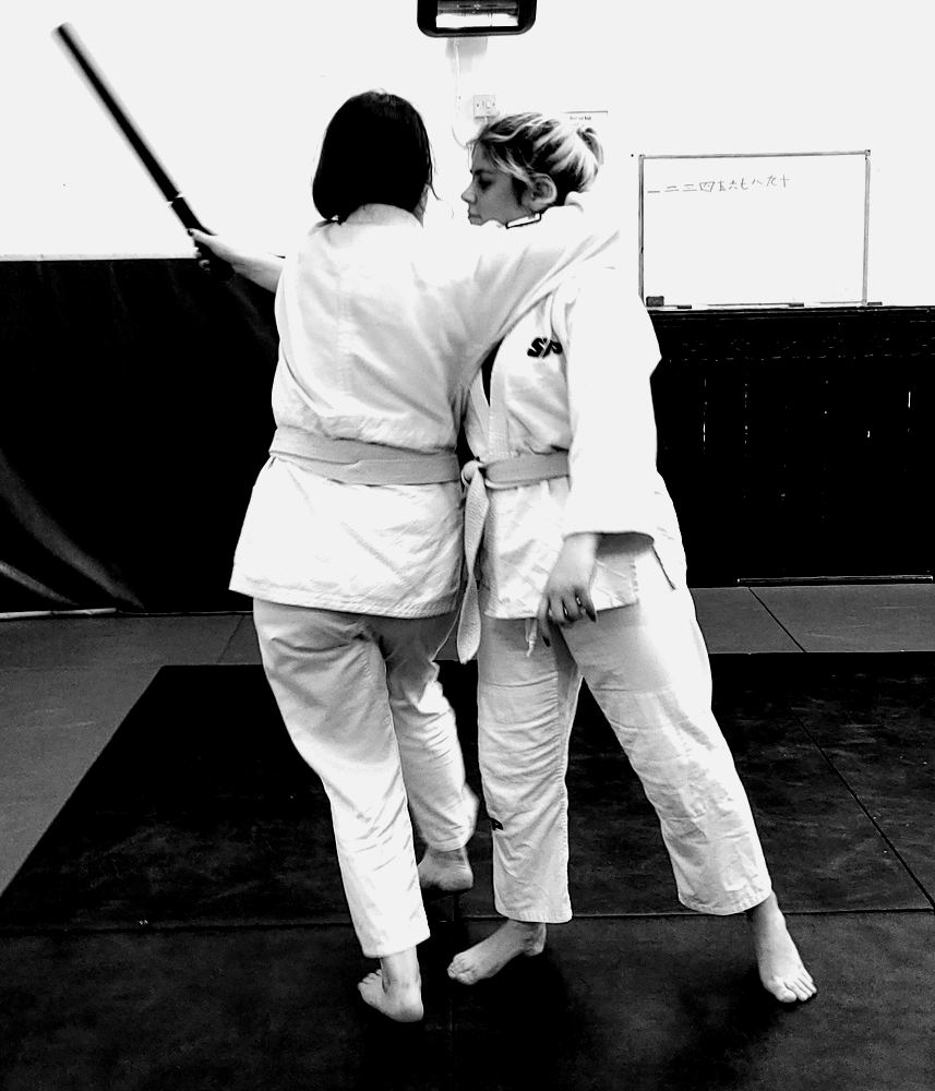 Students practising a defence against a stick attack