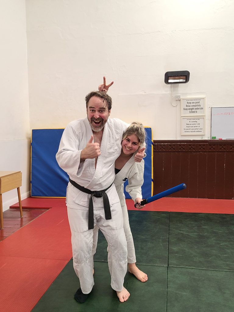 Sensei Simon Hewings, Lead Instructor at Brighton Jitsu Club, in a white gi and black belt